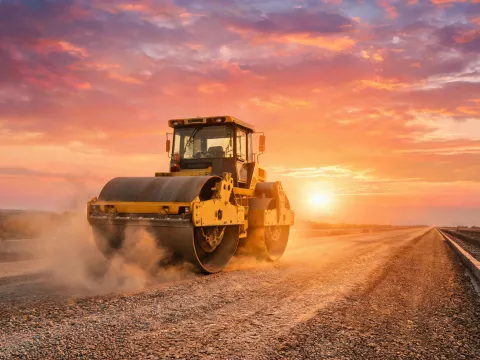 Tandem roller compacting highway base course