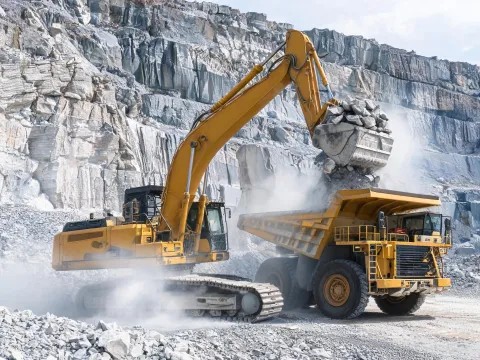 Crawler excavator loading at quarry